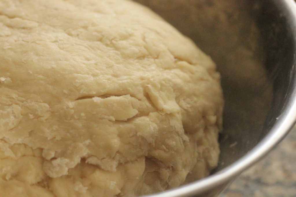 dough rising in a metal bowl
