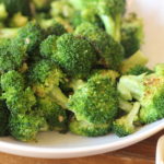 broccoli cooked with butter and garlic in a white bowl