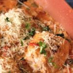 Creamy chicken and spinach topped with parmesan and basil