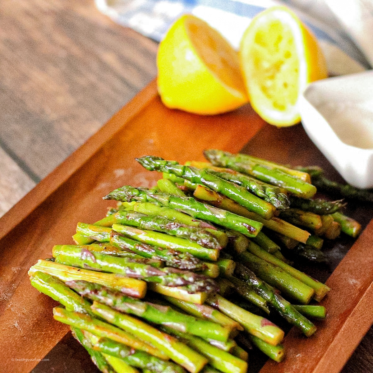 sliced asparagus on a wooden serving platter