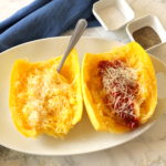 spaghetti squash cooked with spaghetti sauce and cheese in the center