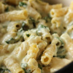 close up image of cheesy rigatoni noodles