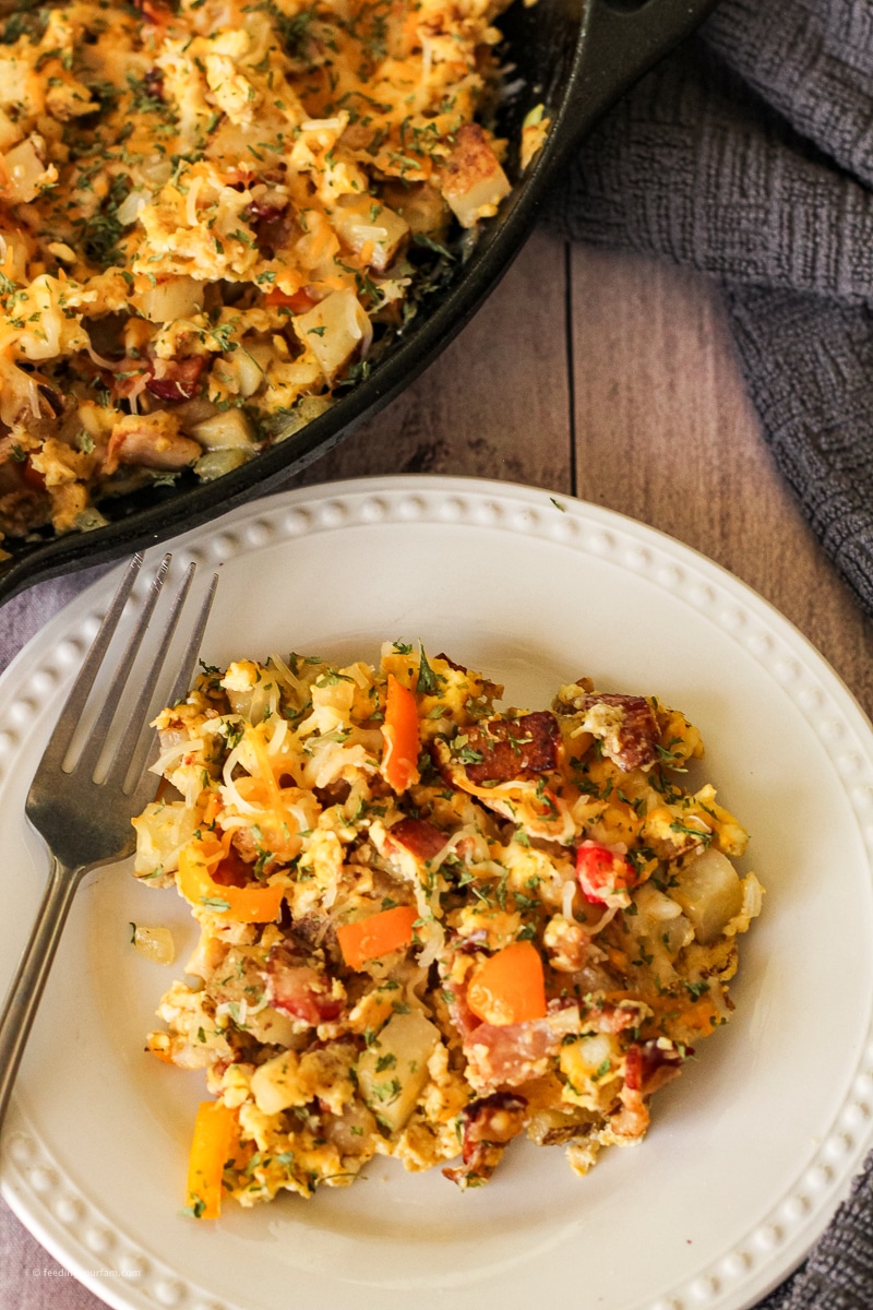 Breakfast Hash is loaded with eggs, BACON, potatoes, onions, pepper and covered in melted cheese!! This is the perfect breakfast to get the fam out the door full and ready to tackle another crazy day! breakfast//brunch// #breakfast #brunchideas breakfast hash with potatoes, eggs, cheese