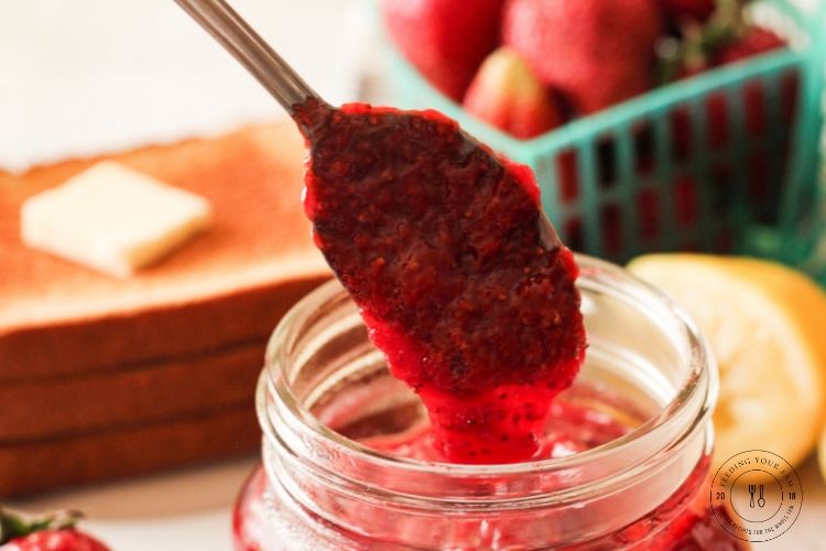 Strawberry Jam//Freezer Jam// Berry Jam #freezerjam #strawberryrecipes spoon dripping strawberry jam into a jar