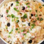 warm potato salad in a white bowl