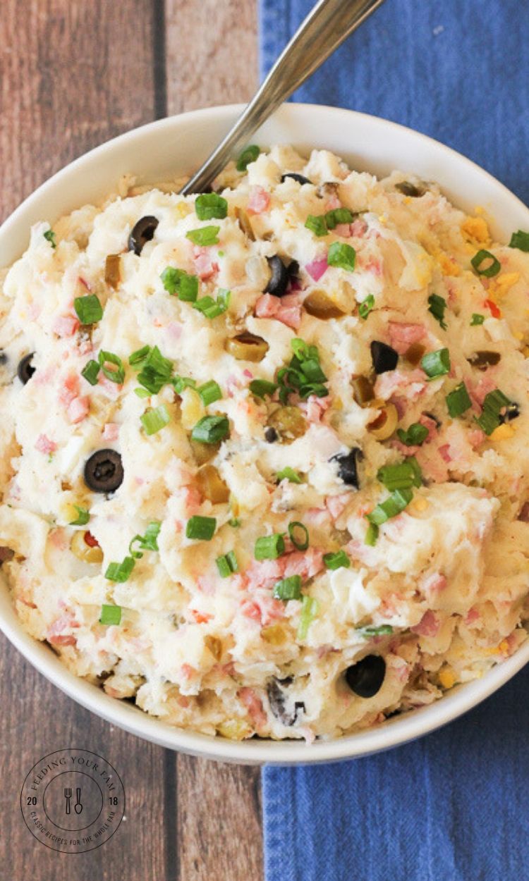 warm potato salad in a white bowl