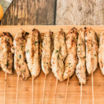 chicken kabobs on a wooden cutting board