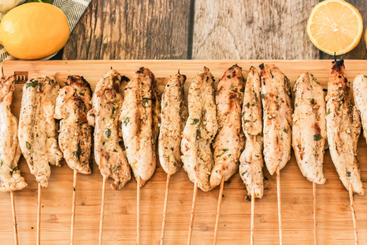 grilled chicken kabobs on a wooden cutting board