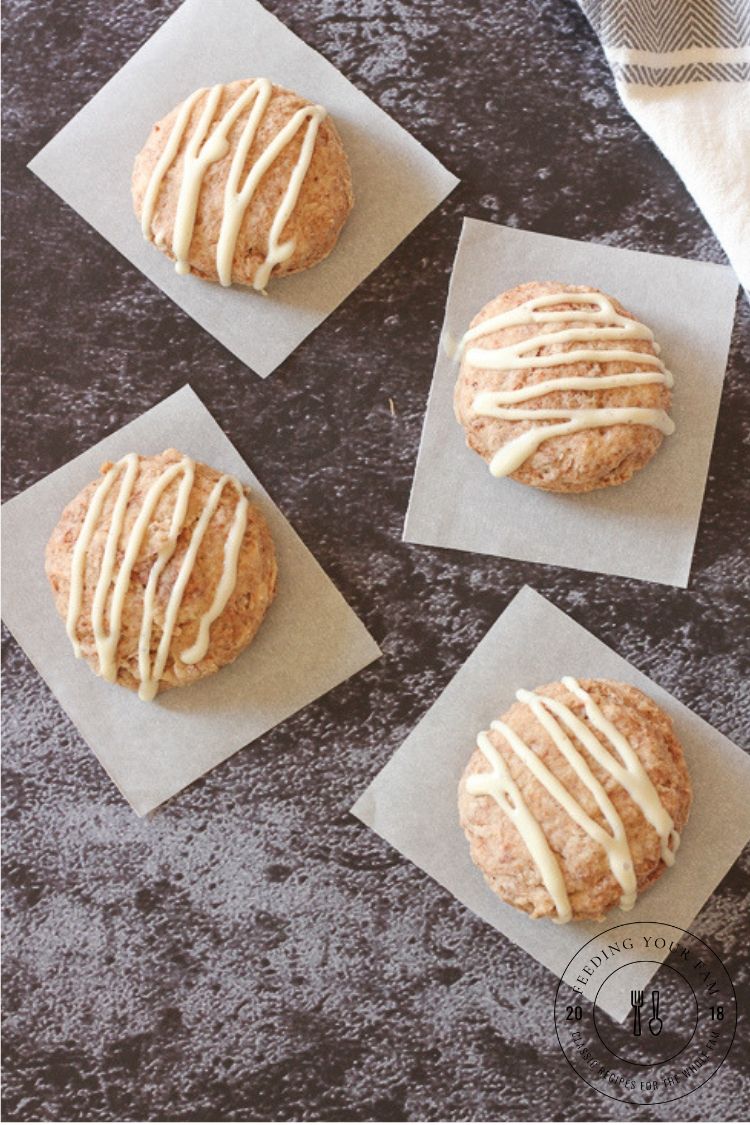 These Cinnamon Biscuits with Cream Cheese Frosting are golden, flaky biscuits with a cinnamon sugar twist, like having a cinnamon roll in under 20 minutes!! The Cream Cheese Frosting is creamy and delicious and just takes these biscuits over the top!! #biscuits #buttermilkbiscuits #breakfast #brunch cinnamon biscuits on parchment paper