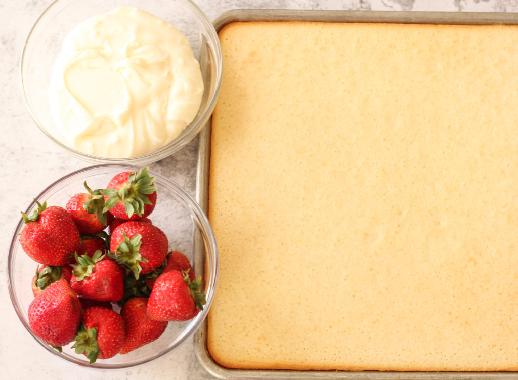 sheet cake and frosting and strawberries