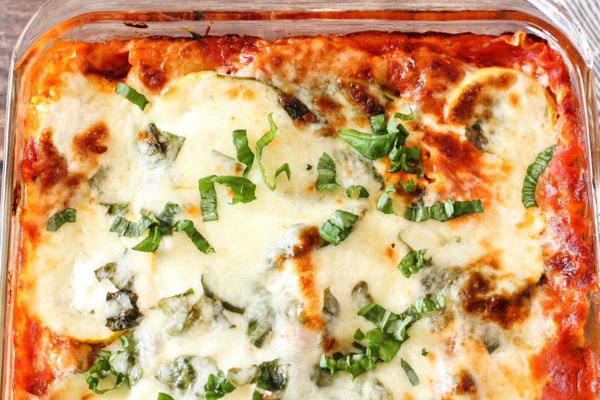 This Easy Vegetable Lasagna Recipe is loaded with fresh zucchini, yellow squash and spinach! Layered with lasagna noodles cheese and marinara, this is the perfect recipe for Feeding Your Fam or sharing with friends! #veggielasagna #lasagna lasagna