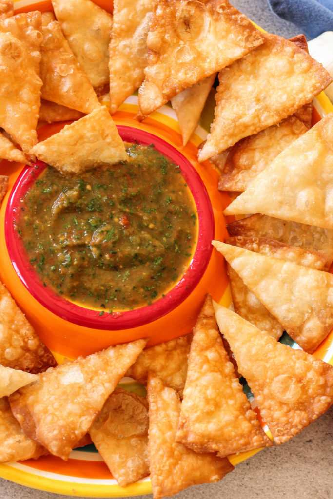 Use your air fryer to make a delicious roasted tomato salsa!! dish with salsa in the center surrounded by chips.
