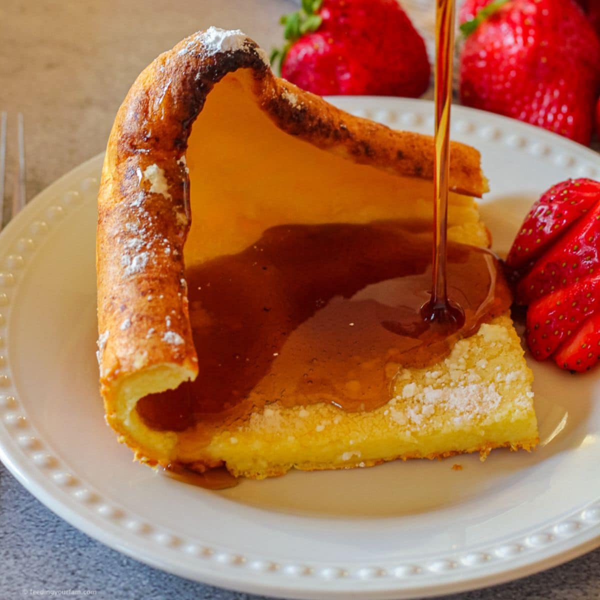 German pancakes recipe being drizzled with syrup