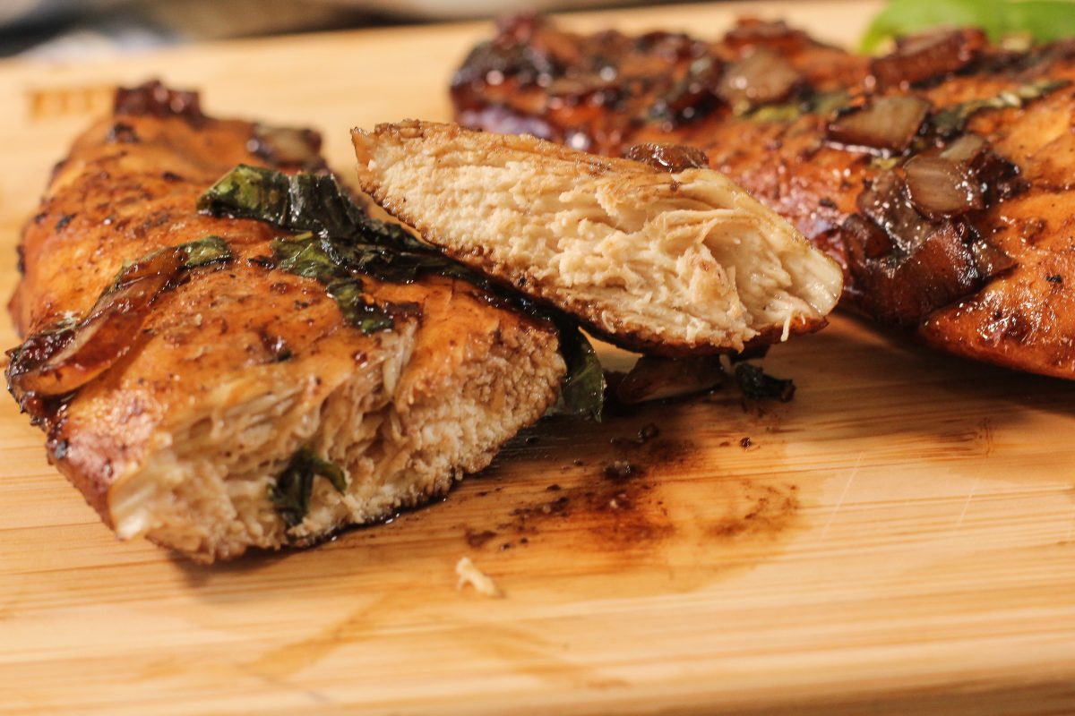 sliced chicken on a wooden cutting board