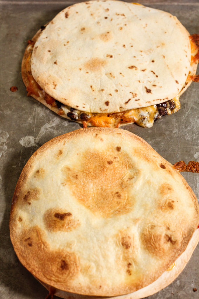 golden brown quesadillas on a baking sheet
