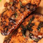 cooked chicken on a wooden cutting board