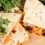 vegetable black bean quesadillas on a wooden platter