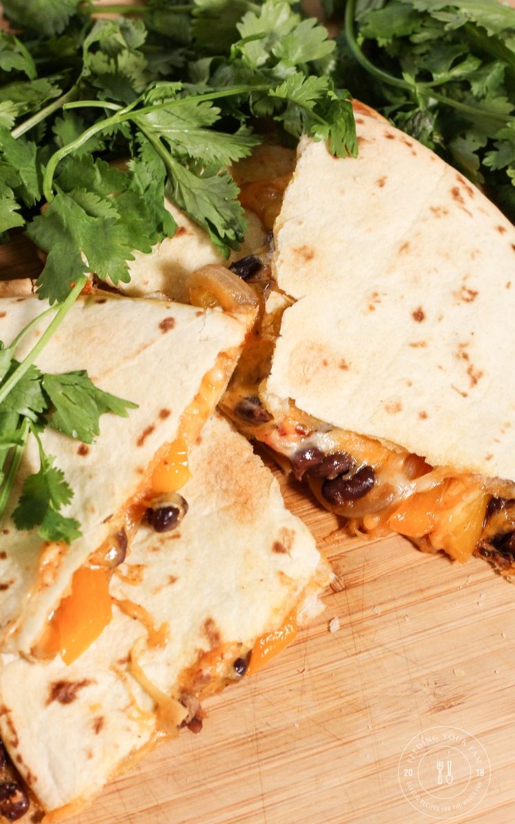 vegetable black bean quesadillas on a wooden platter