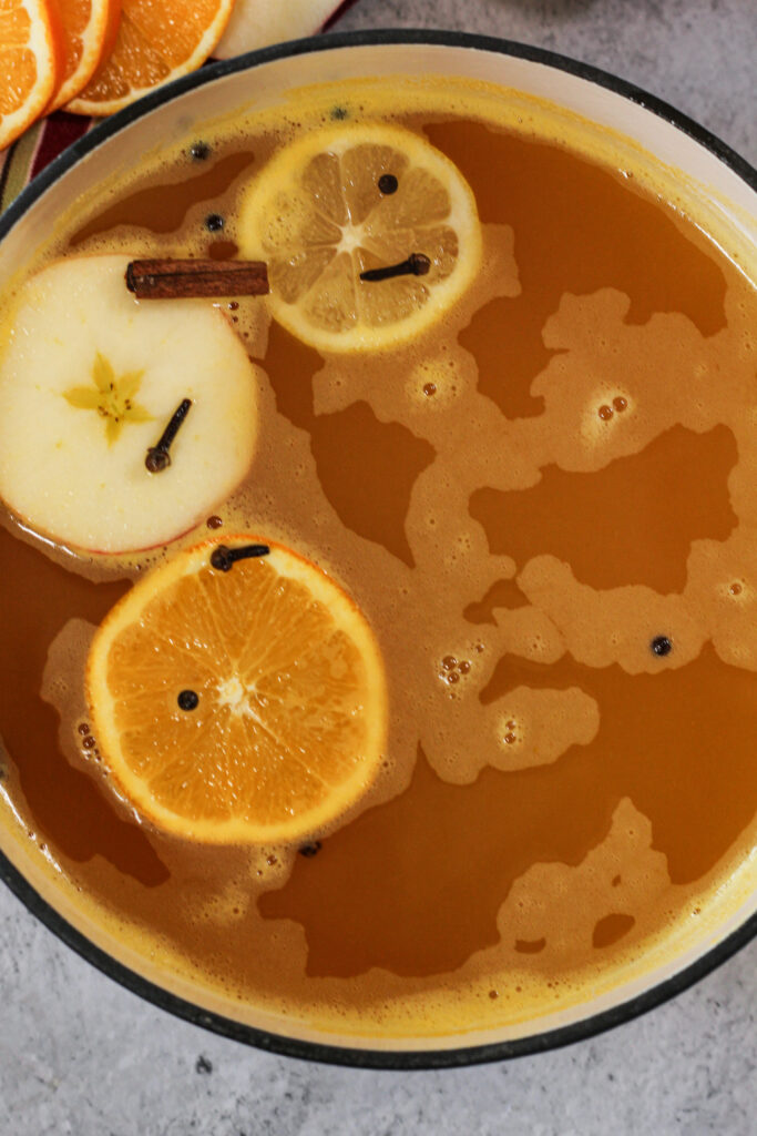 Wassail is a delicious warm drink made up of apple cider, orange juice and lemon juice. Perfectly seasoned to warm you to the core. Wassail is perfect for cold winter days, Holiday parties and Christmas celebrations. warm wassail in a pot