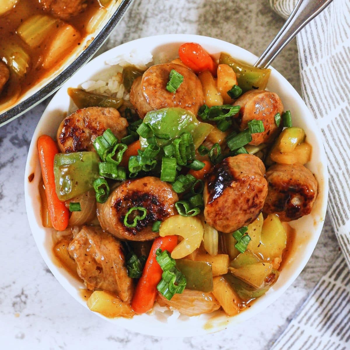 sweet and sour sausages in a white bowl