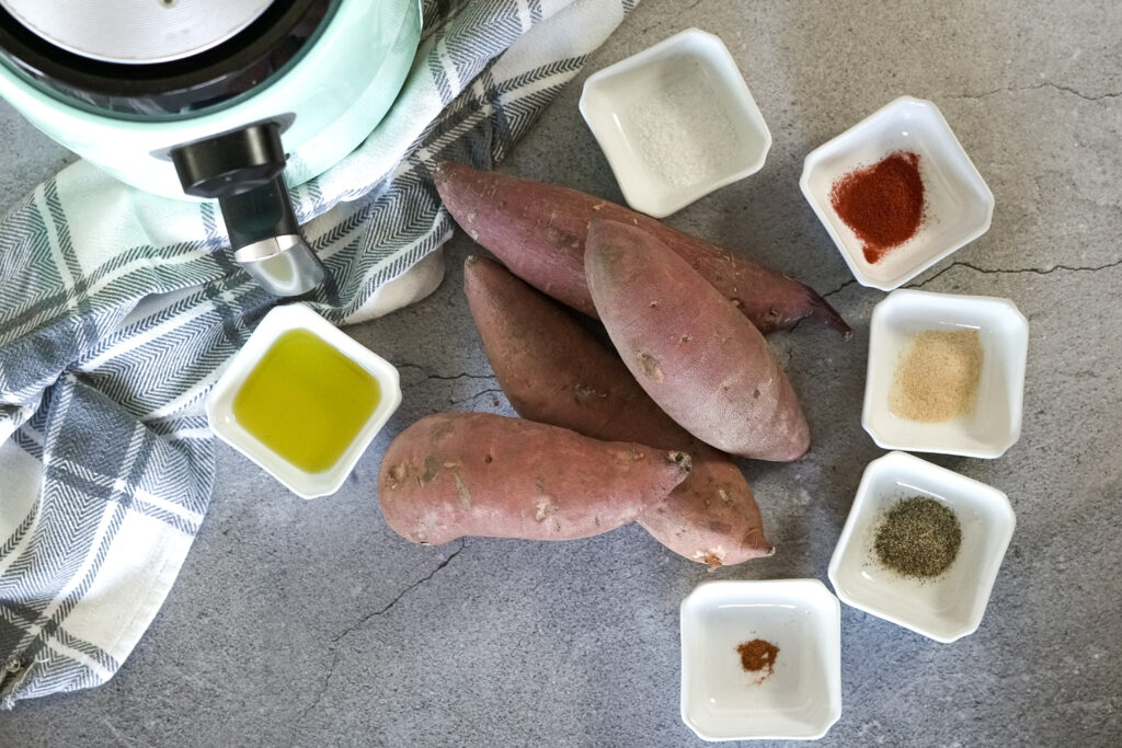 sweet potatoes surrounded by little bowls of spices 