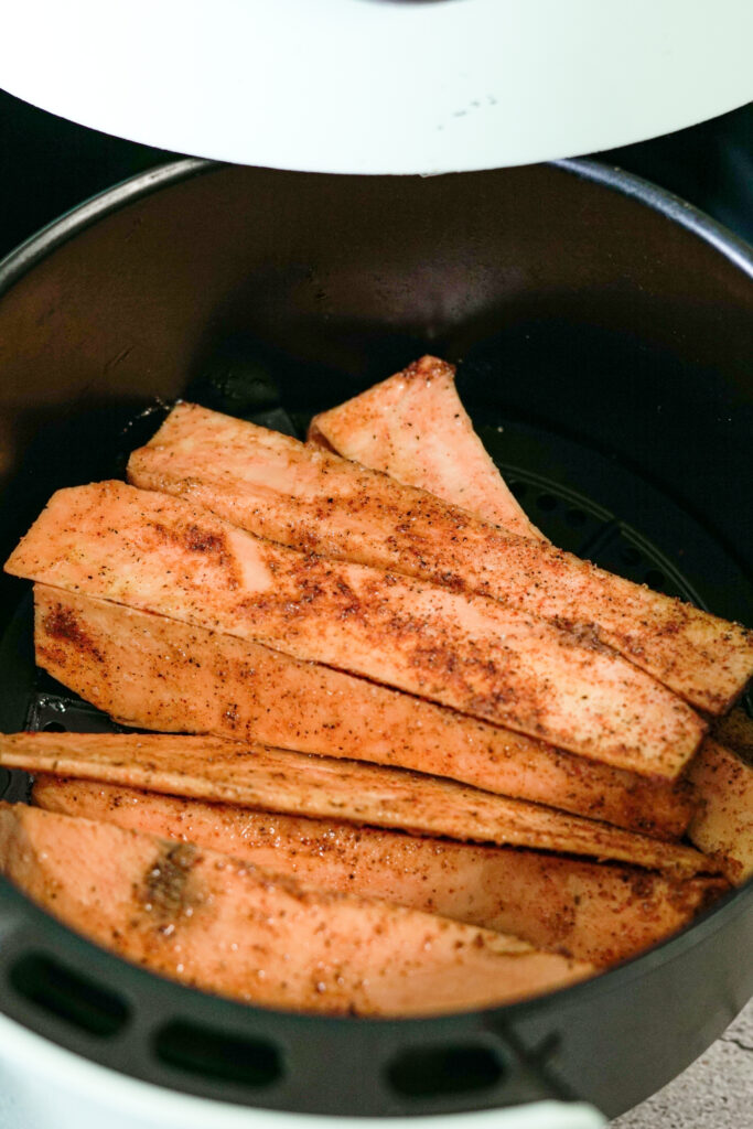 seasoned sweet potatoes in air fryer basket