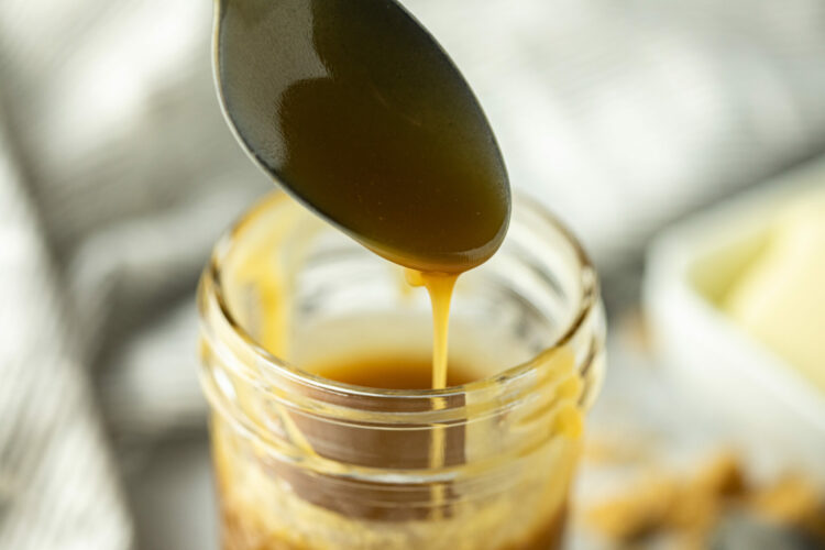 drizzling caramel sauce into jar