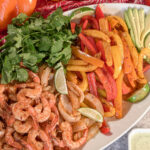 plate with shrimp, peppers and onions