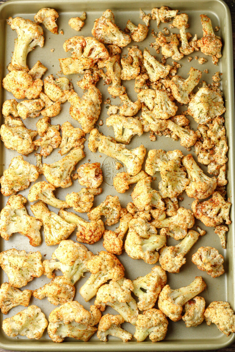 seasoned cauliflower florets on a baking sheet