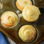 orange rolls in a muffin tin