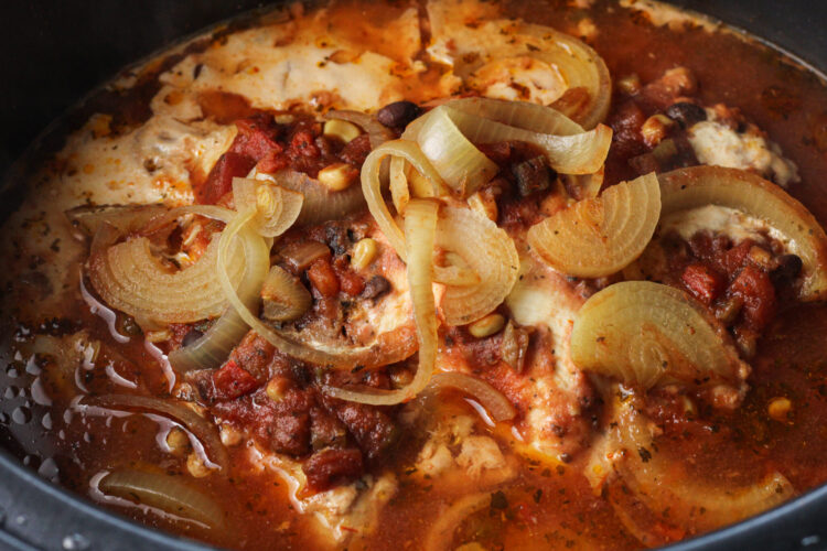 cooked chicken and salsa in a crock pot