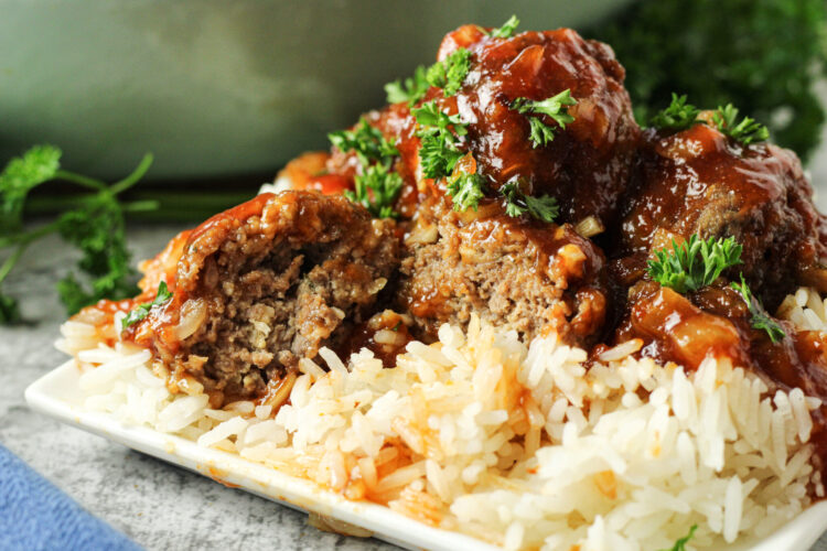 meatball sliced in half over rice