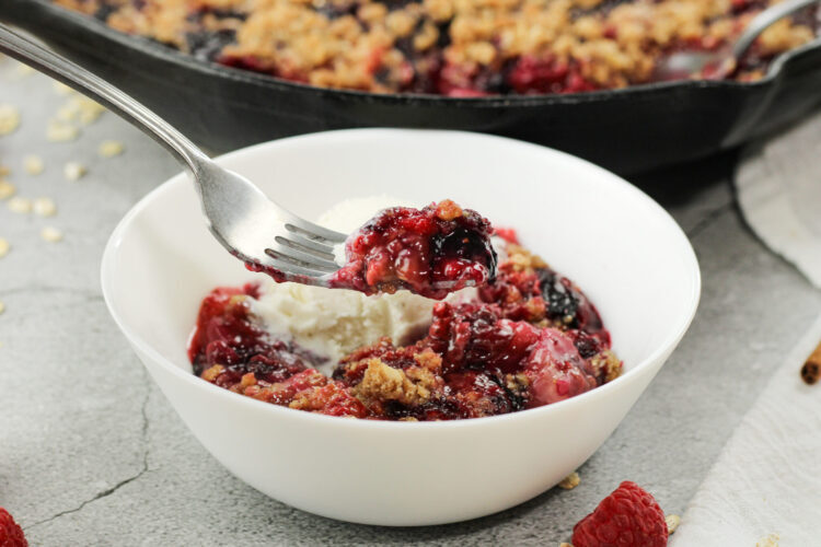 fork holding some triple berry crisp
