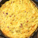 baked ham and cheese frittata in a cast iron skillet