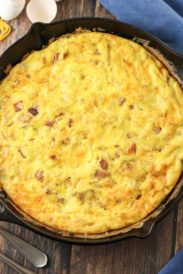 baked frittata with ham and cheese in a cast iron skillet