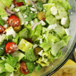 green greek garden salad with tomatoes, feta cheese, red onions, cucumbers and green onions