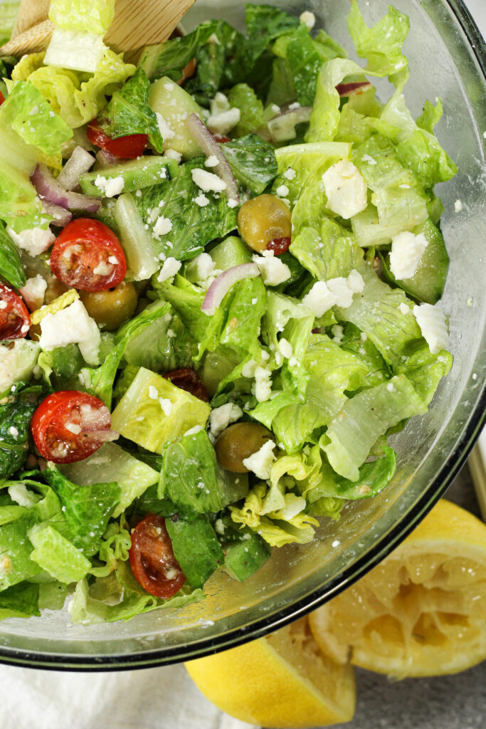 green greek garden salad with tomatoes, feta cheese, red onions, cucumbers and green onions