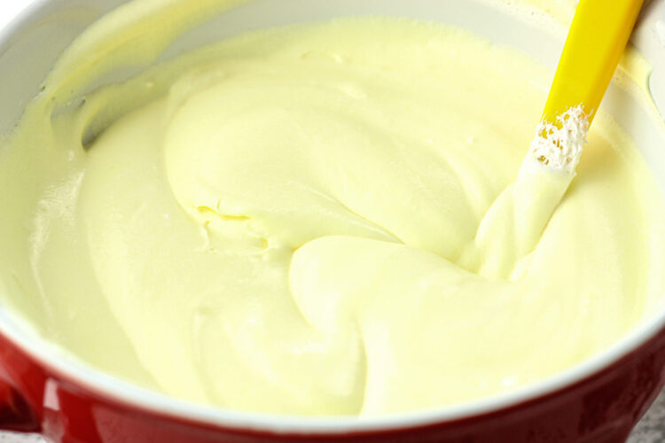 mixed lemon dip in a red mixing bowl