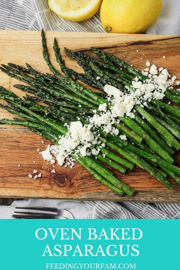 Oven Baked Asparagus is a simple way to enjoy fresh asparagus. This easy oven roasted asparagus only takes a few ingredients and is ready in under 15 minutes. Asparagus is a delicious side dish that goes with all of your dinner ideas. asparagus on a wooden platter sprinkled with feta cheese