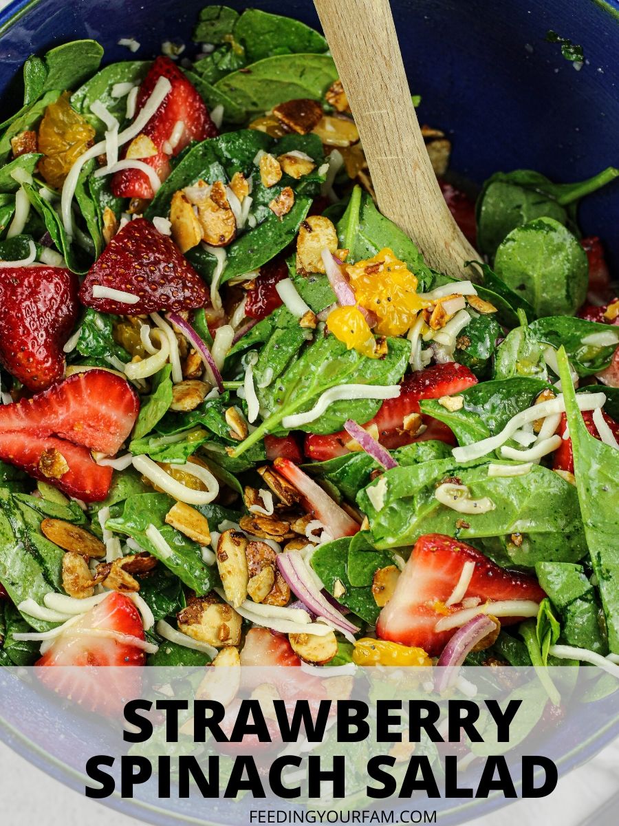 strawberry and spinach salad in a blue salad bowl