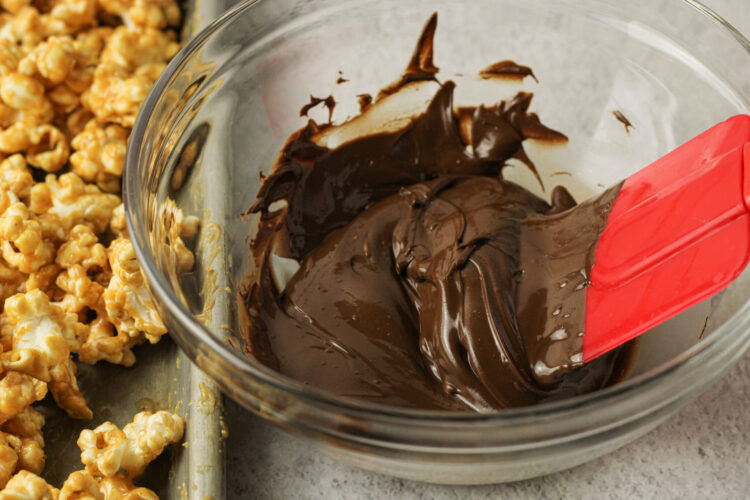 melted chocolate in a bowl with a red spatula