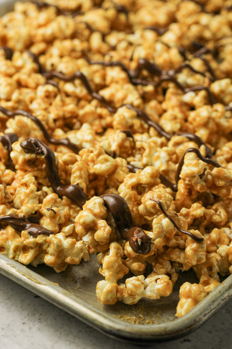 peanut butter covered popcorn with chocolate drizzle