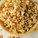 bowl of peanut butter popcorn with chocolate drizzle