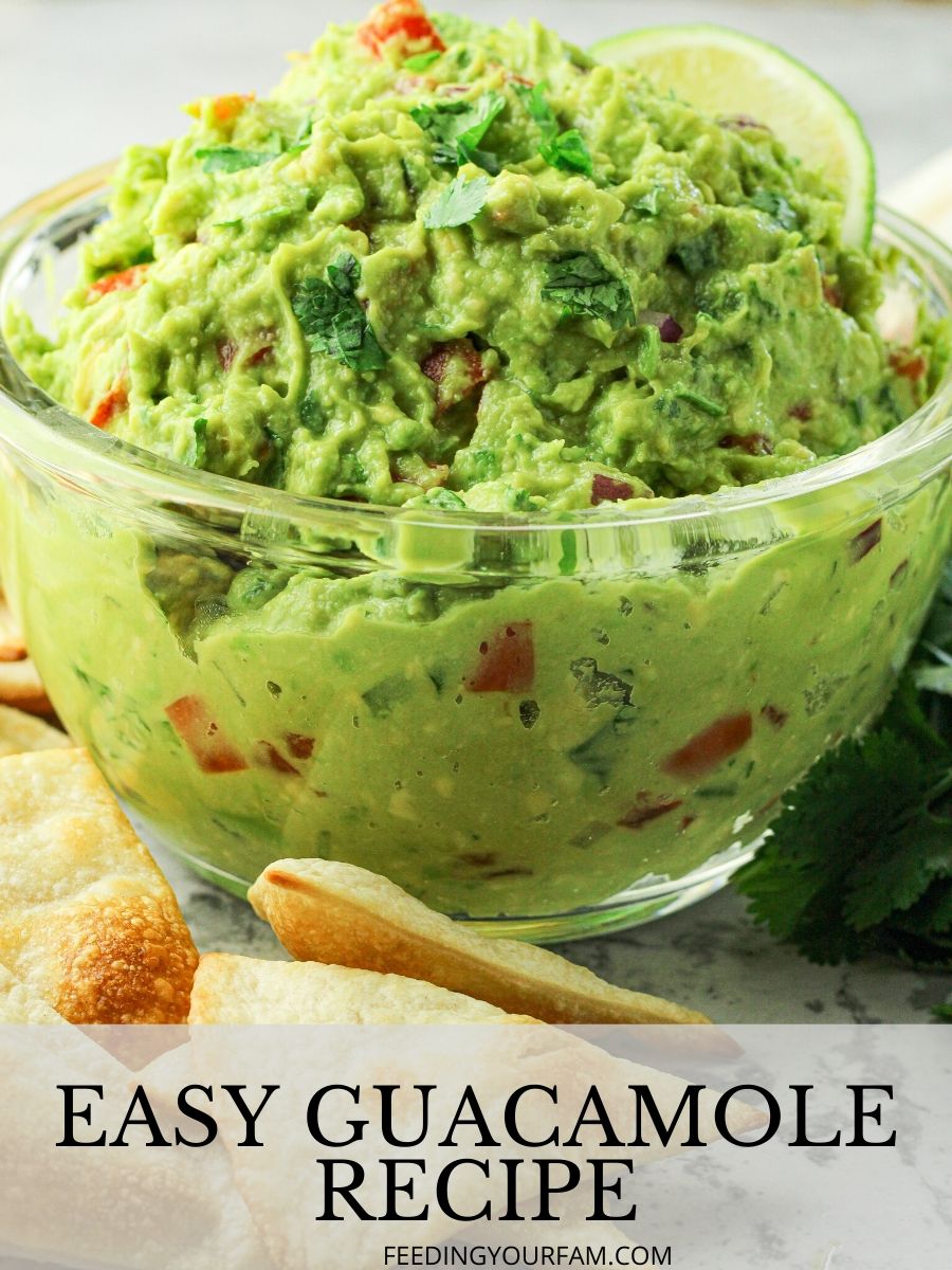 This Easy Guacamole Recipe is a classic, loaded with fresh avocados, lime juice, red onion, cilantro, tomatoes and simple spices. The best guacamole recipe starts with simple ingredients. This will definitely be on repeat at your home, like it is at ours. guacamole in a glass bowl with the words easy guacamole underneath