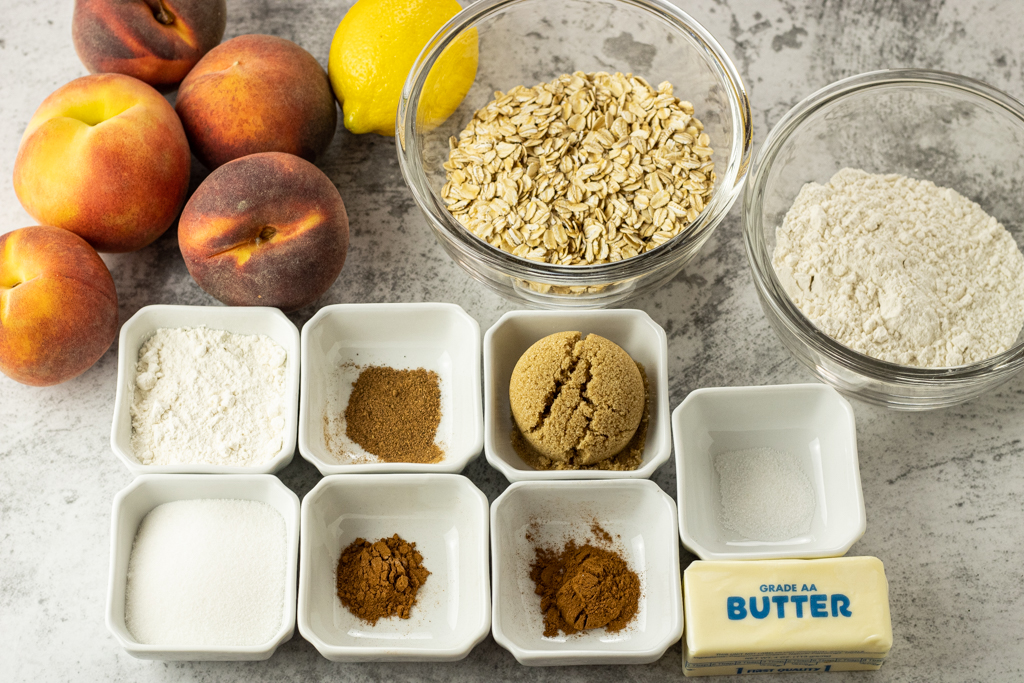 peaches, lemon, oats, flour, cinnamon, nutmeg, brown sugar and a cube of butter to make peach crisp recipe