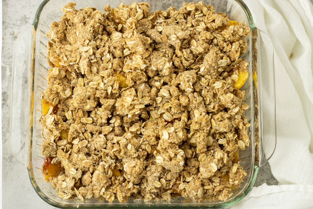 oat topping on top of peaches
