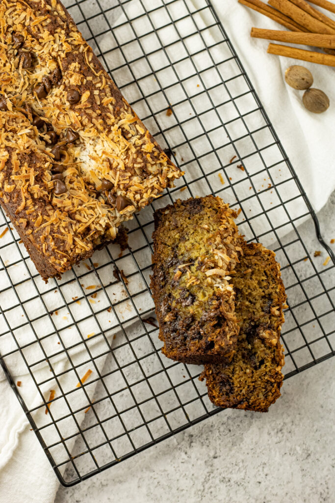 sliced of banana chocolate chip bread on a cooling rack