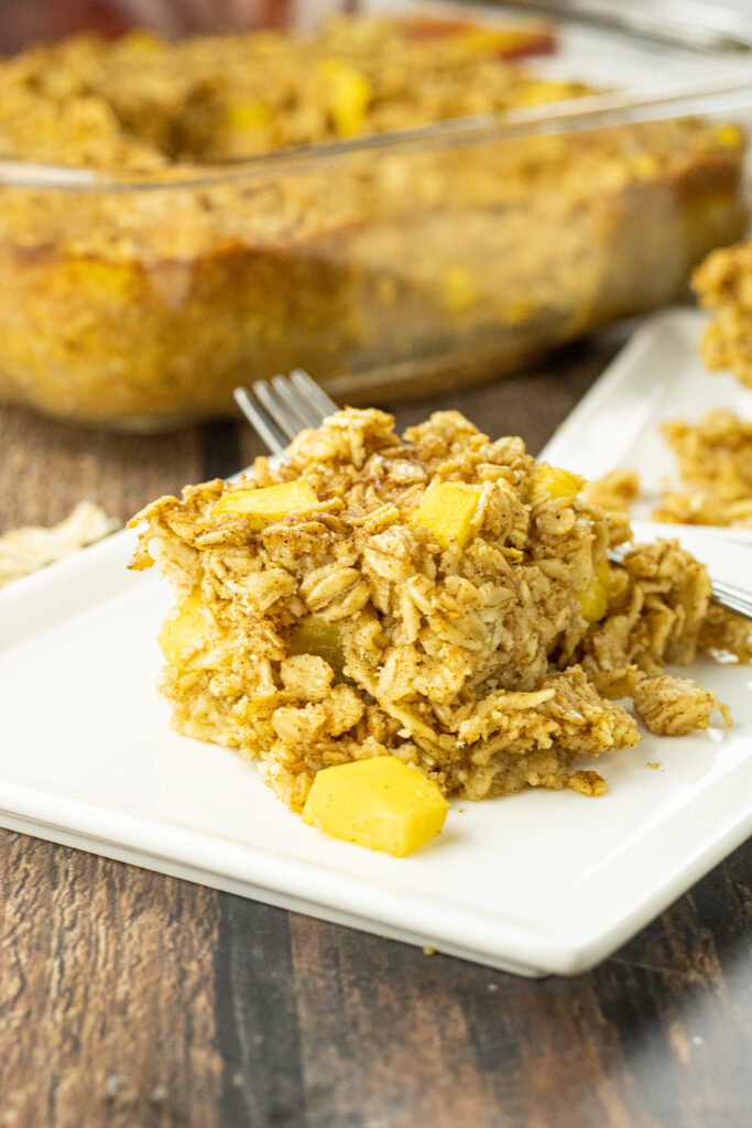 piece of baked oatmeal with peaches on a white plate