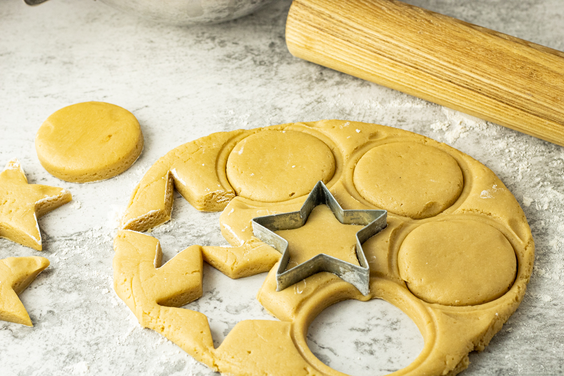 cutting out brown sugar cookies with a cookie cutter