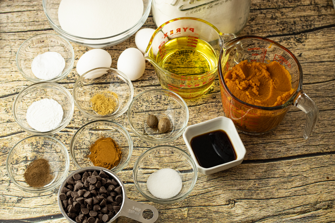 Ingredients for pumpkin bread in bowls and measuring cups